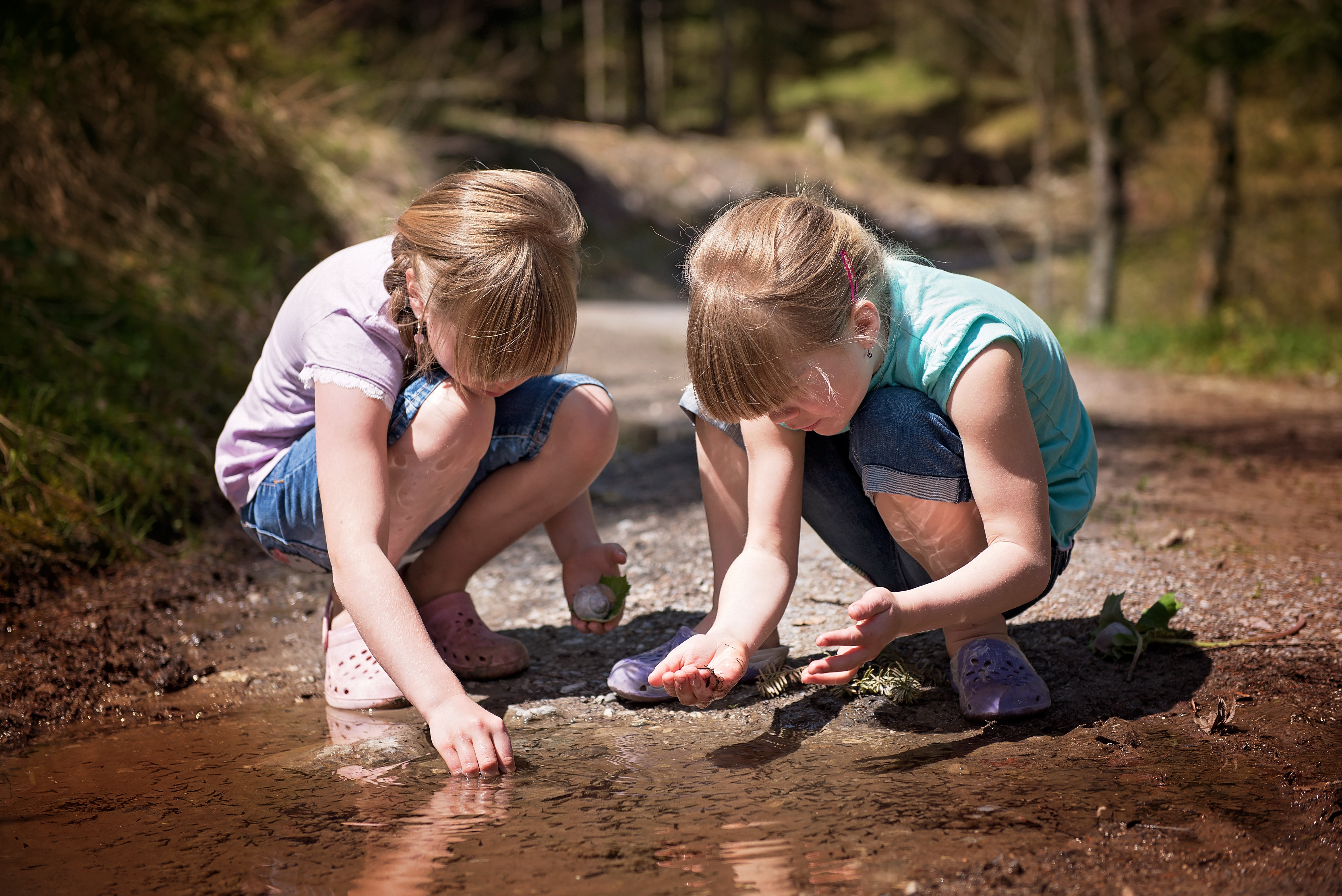 Children exploring outdoors during a scavenger hunt adventure